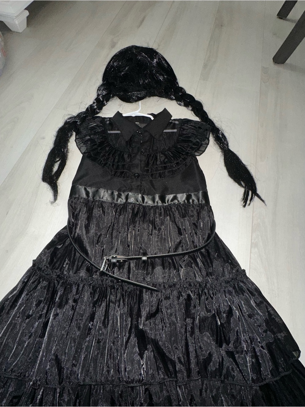 Wednesday Addams costume with wig and belt. Button front closure.